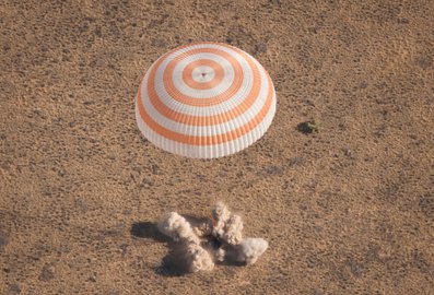 Soyuz firing retrorockets just before landing