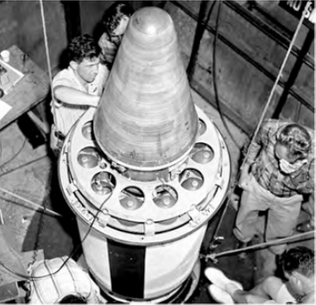 Sub-scale Jupiter-C reentry vehicle being installed on top of a modified Redstone rocket